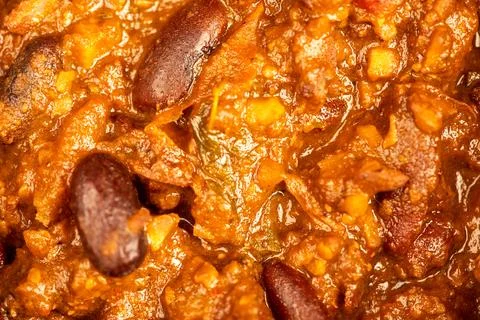 Stewed beans with meat in a small pot. A traditional rustic dish. Close-up, s Stock Photos