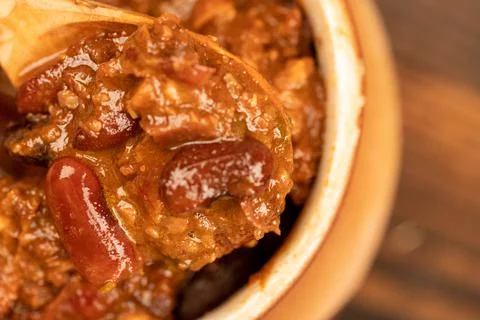 Stewed beans with meat in a small pot. A traditional rustic dish. Close-up, s Stock Photos