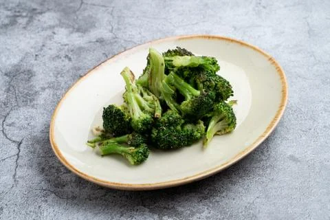 Stewed broccoli as a side dish in a restaurant on grey stone table Stock-Fotos