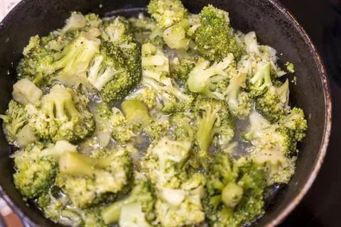 Stewed cauliflower in a frying pan while cooking a vegetarian dinner Stock Photos