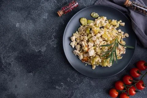 Stewed chicken minced meat with vegetables zucchini pepper spices on a blac.. Foto stock