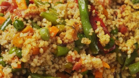 Stewed couscous with vegetables, green onion, carrots and tomatoes in milk Stock Footage 311541069