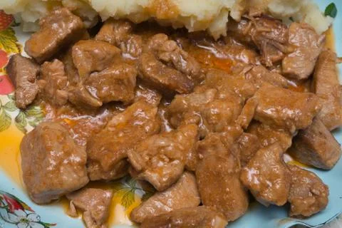 Stewed meat with mashed potatoes on a dish 스톡 사진