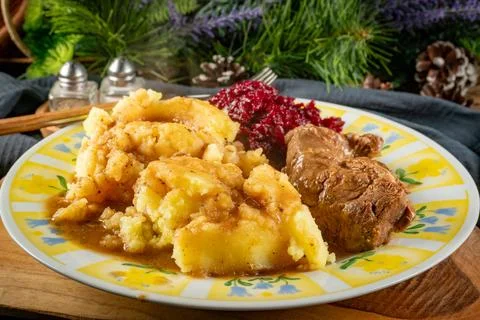 Stewed meat served with mashed potatoes and grated beetroot. Stock Photos