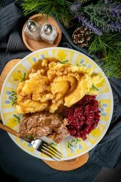 Stewed meat served with mashed potatoes and grated beetroot. Stock Photos