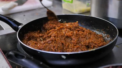 Stewed vegetable mass in a frying pan, frying process, vegetable dressing for Stock Footage 291257321