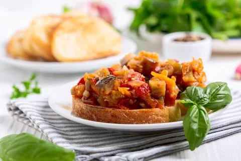 Stewed vegetables on a slice of bread. Stock Photos