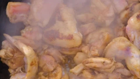 Stewing meat in a cauldron.The meat is stewed in a cauldron. Chicken meat is Stock Footage 278463345