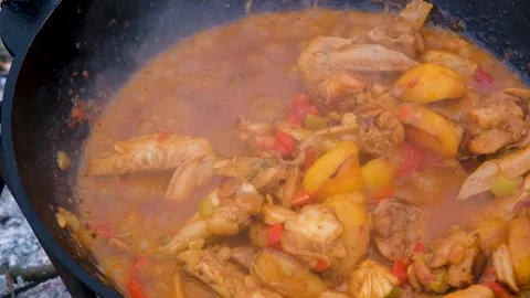 Stewing meat in a cauldron. The meat is stewed in a cauldron. Chicken meat is Stock Footage 284173434