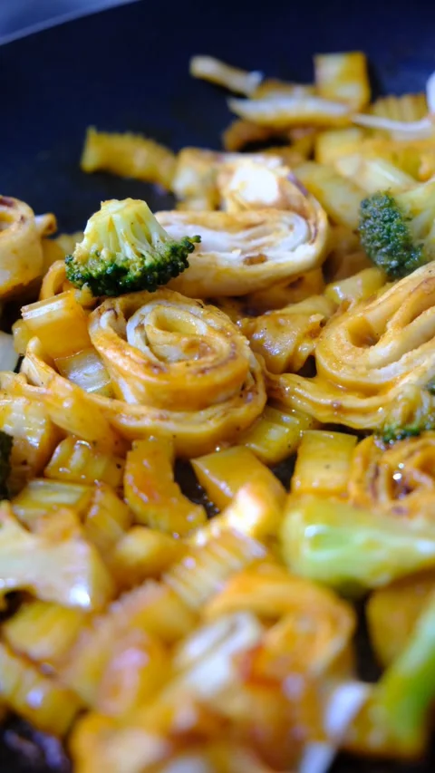 Stewing vegetables, broccoli, celery and filo pastry on cast iron, Stock Footage 346580249
