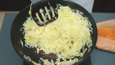 Stewing young cabbage in a wok pan Stock Footage 250359997
