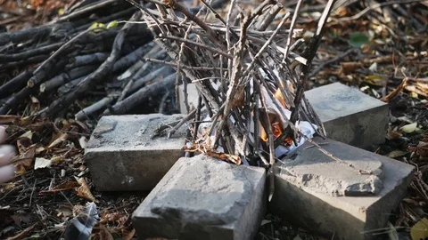 A stick is placed into a burning campfire. A medium shot of a campfire burnin 動画素材 118464069