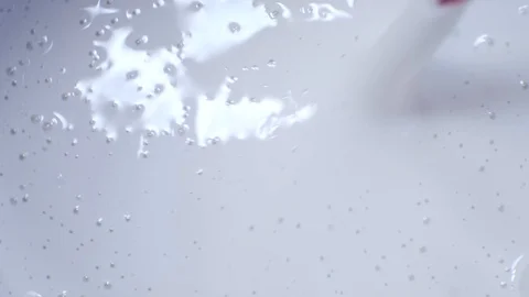 Stick stirs thick liquid.closeup.view from above.abstract background Stock Footage 105681152