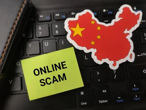 A sticker map of China with its flag pattern is placed on a keyboard next t.. 库存照片