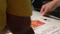 Sticking competition sticker to car metal surface, exhibition HD Footage