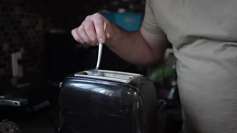 Sticking a Fork in the Toaster and Getting Electrocuted Stock Footage 158061866