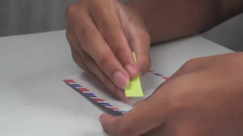 Sticking label stickers on envelopes on table Stock Footage 277177722