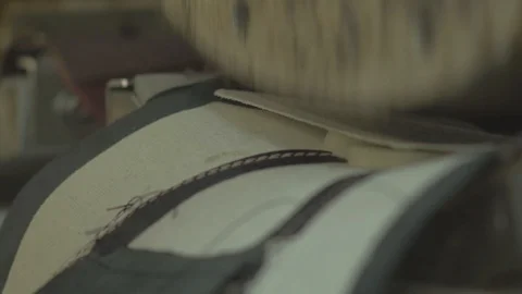 Sticking a lining on a leather using a machine Stock Footage 107965695