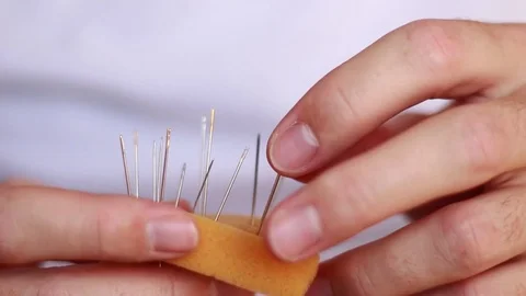 Sticking needle into a needle pillow Stock-Footage 73506206