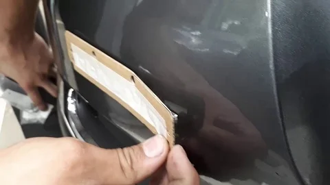 Sticking Renault sticker on the tailgate Stock Footage 94442444