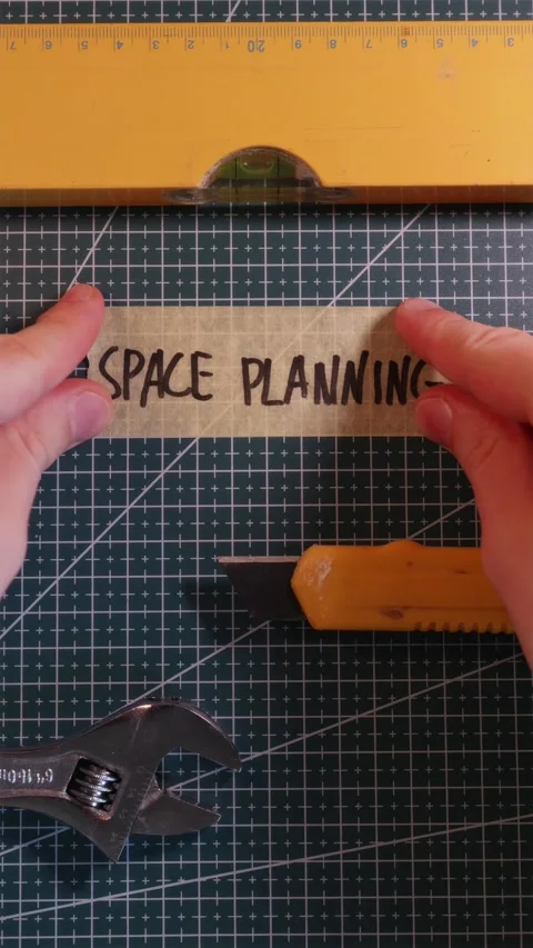 Sticking SPACE PLANNING tape label near tools. Stock-Footage 337816364
