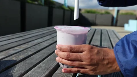 Sticking a straw into a bubble tea Stock Footage 277421071