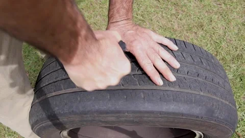 Sticking tire plug tool into a tire for a repair of a flat tire Stock Footage 164261906