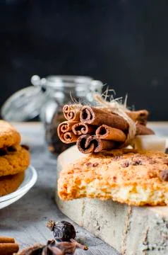 Sticks cinnamon, anise, biscuits  on dark   background Stock Photos