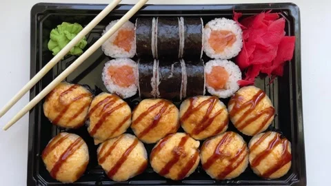 Sticks Take Sushi on light background. Variety of types sushi with red caviar Stock Footage 280335411