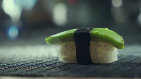Sticks taking vegetarian sushi from table, Closeup of eating vegan sushi filled Video stock 153699891