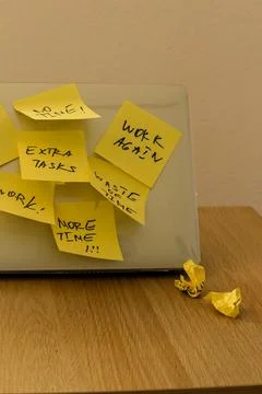 Sticky note is attached to a laptop screen Stock Photos