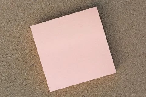 Sticky note on brown paper background. Directly above. Flat lay. Stock Photos
