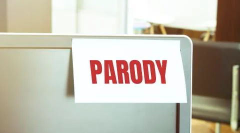 Sticky note on the computer. Text PARODY Stock Photos