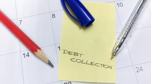 A sticky note labeled "Debt Collection" affixed to a calendar, serving as a.. Stock Photos