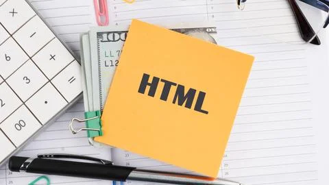 A sticky note labeled HTML is prominently displayed on a desk full of items.. Stock Photos