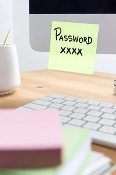 Sticky Note with Password on Computer Showing Security Risk Stock Photos