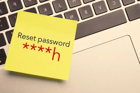 Sticky note with phrase Reset Password on laptop, top view Stock Photos