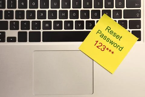 Sticky note with phrase Reset Password on laptop, top view Stock Photos