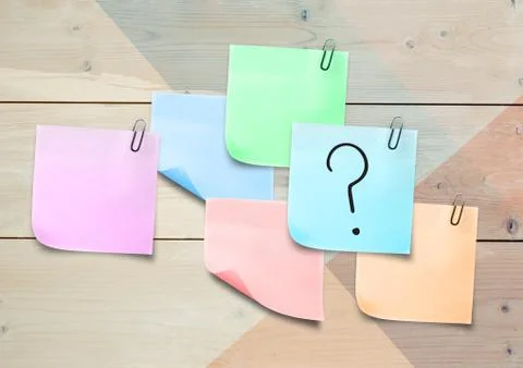 Sticky Note with Question Icon against a wood wall Stock Photos