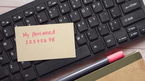 Sticky note with simple numeric password on computer keyboard representing .. Video stock 333030336