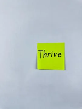 Sticky note with Thrive written on it, set on a white background. This image  Stock Photos