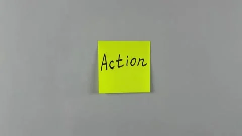 Sticky note with the word Action written on it, pinned on white background Stock Footage 305329509