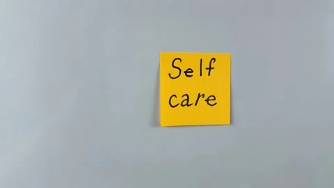 Sticky note with word Selfcare written on it, pinned on white background Stock Footage 305329752