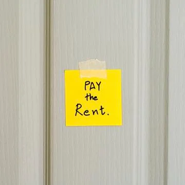 Sticky note write a message pay the rent Stock Photos