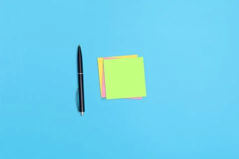 Sticky notes and a pen on the table Stock Photos