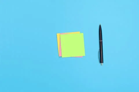 Sticky notes and a pen on the table Stock Photos