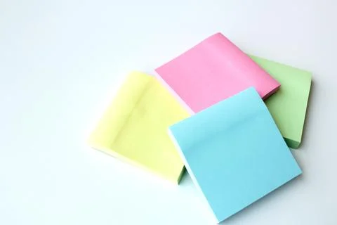 Sticky notes in four pastel colors. Stock Photos