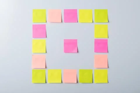 Sticky notes on grey wall Stock Photos