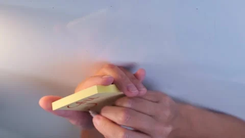 Sticky notes with handwritten reminders on wall in close-up view, showing tasks Stock Footage 333769177
