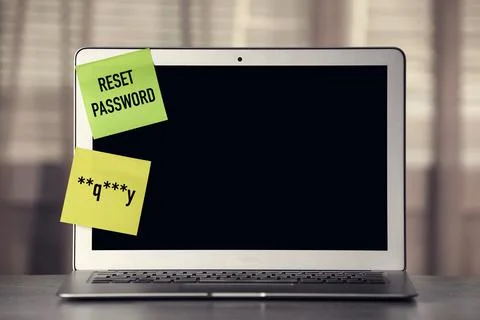 Sticky notes with passcode and phrase Reset Password on laptop. Space for tex Stock Photos